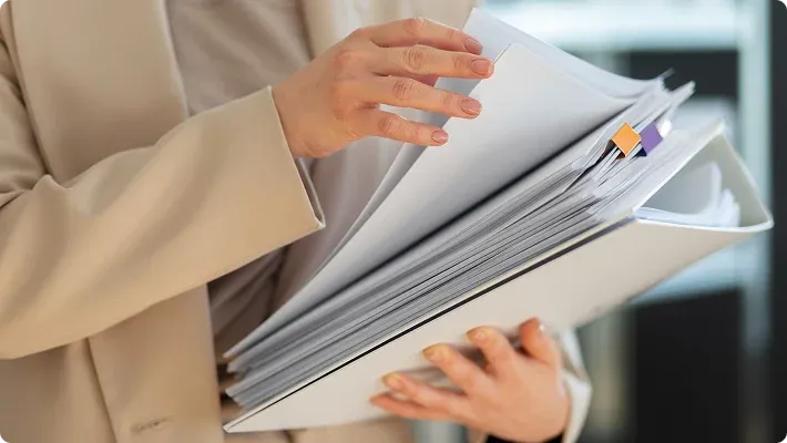 Hands holding documents