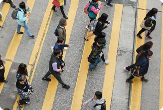 Pedestrians crossing a busy city street in Melbourne